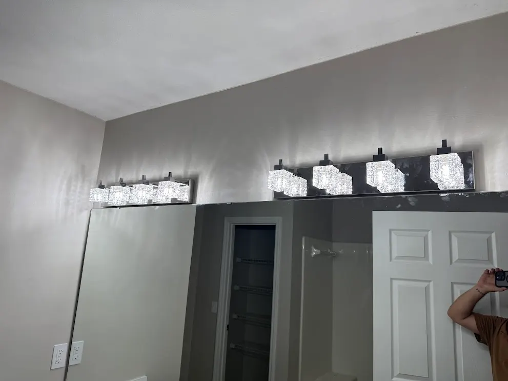 Bathroom vanity with updated light fixtures above the mirror
