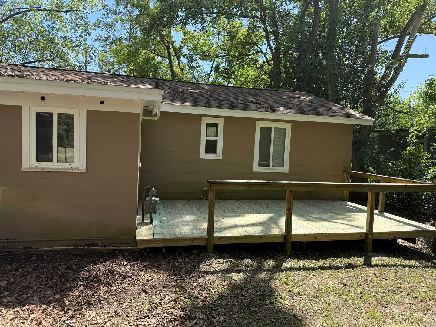 Side-yard deck with new wood boards and railing