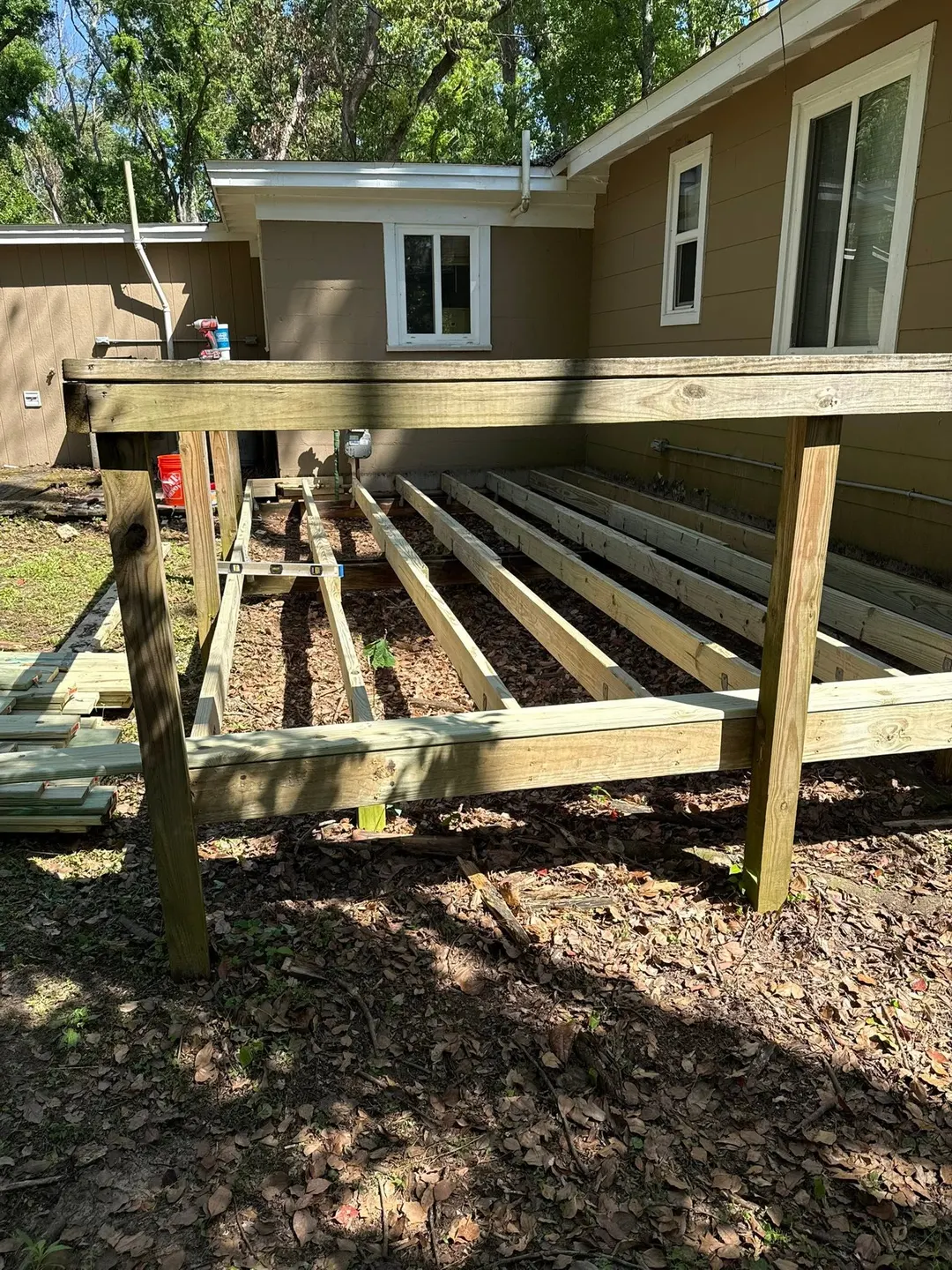 Deck framing and railing repair work in progress