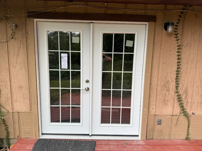 New white French doors installed on an exterior wall