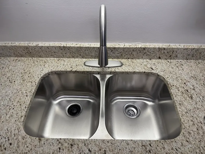 Stainless double-basin kitchen sink with faucet