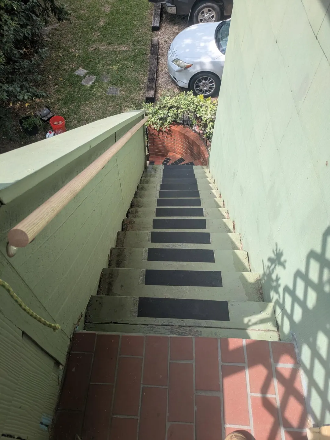 Exterior staircase with handrail along the wall